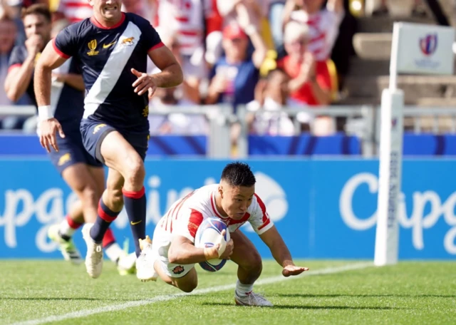 Naoto Saito dives over to score a try