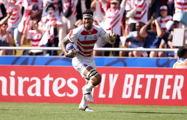 Amato Fakatava of Japan smiles as he crosses the try line