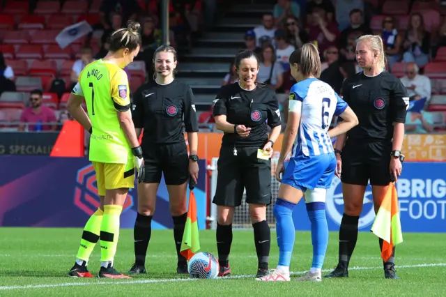 The captains conduct the coin toss before kick off.