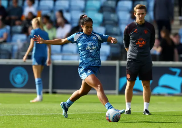 Fowler dribbles the ball in the warm up.