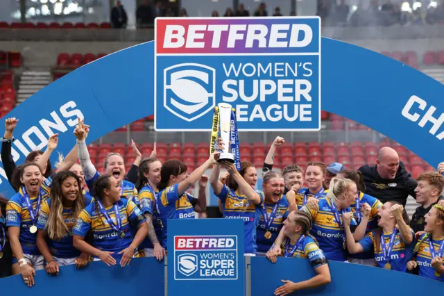 Leeds celebrate their 2022 Grand Final win with the trophy