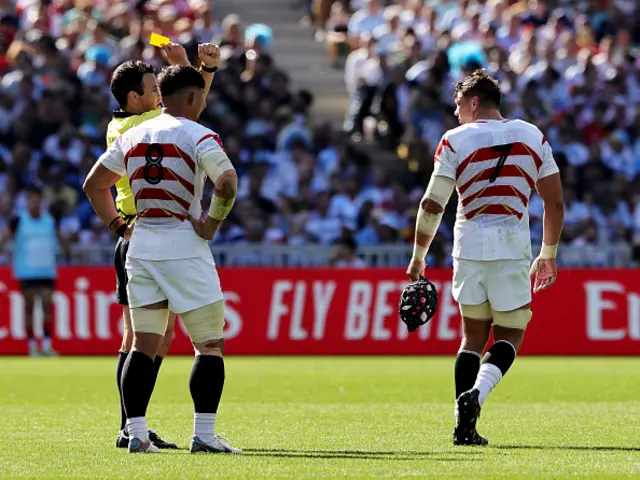 Pieter Labuschagne of Japan leaves the field after receiving a yellow card