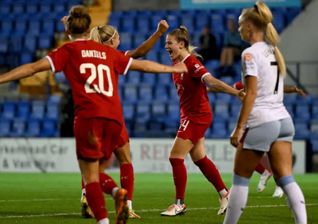 Hobinger screams in delight as she celebrates her goal with teammates.