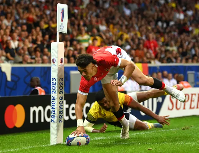 Kyren Taumoefolau of Tonga dives in the corner to score