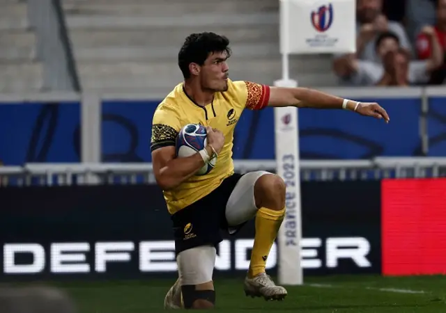 Romania's full-back Marius Simionescu reacts after scoring