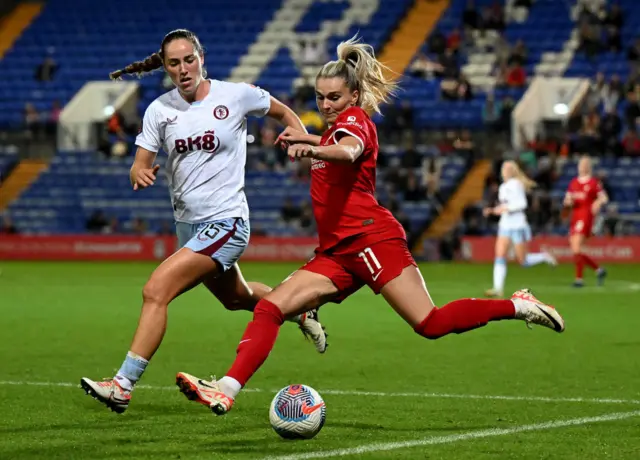 Parker closes down Lawley as she attempts to clear the ball.