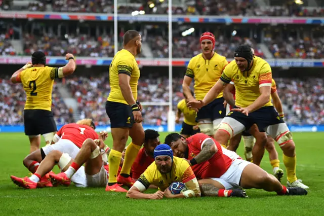 Cristi Boboc of Romania scores as Ben Tameifuna attempts to tackle him