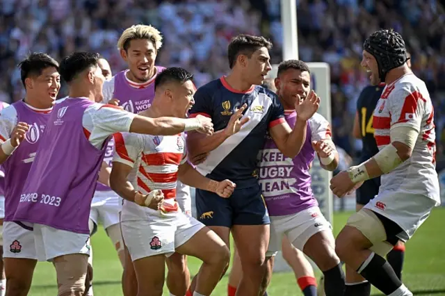 Japan's scrum-half Naoto Saito celebrates with teammates