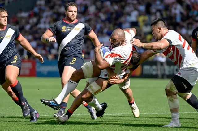 Japan's flanker Michael Leitch is tackled by an Argentina player