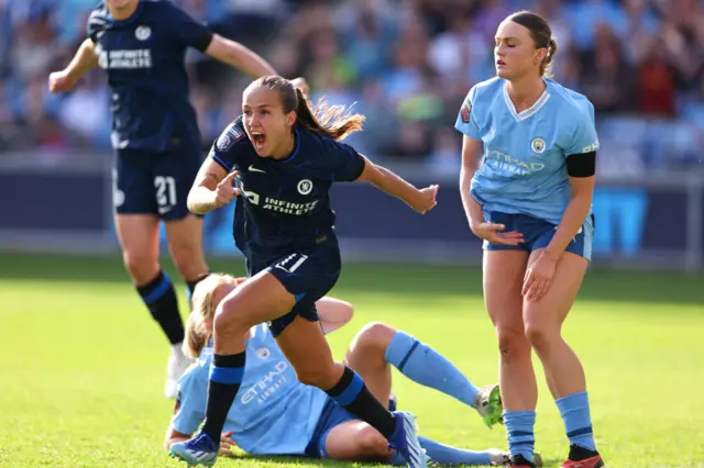 Reiten screams in delight as City players look deflated behind her.