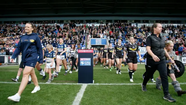 Players come out of tunnel