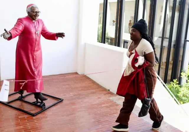 A person walks past a sculpture of the late South Africa's anti-apartheid activist Desmond Tutu, who would have turned 92 years old on the 7th of October, at the Desmond and Leah Tutu building in Cape Town, South Africa, October 6, 2023.