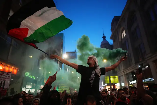 A man waving the Palestinian flag in London