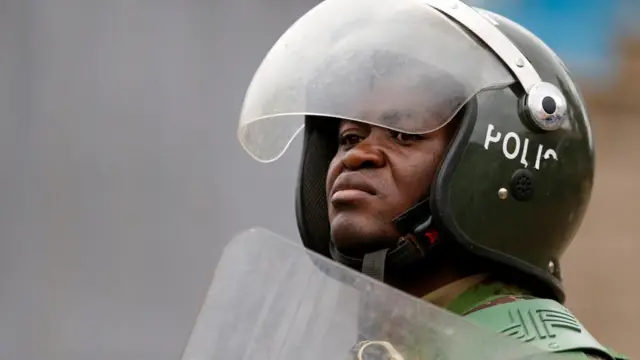 A riot police officer looks on, as supporters of Kenya's opposition leader Raila Odinga of the Azimio La Umoja (Declaration of Unity) One Kenya Alliance participate in an anti-government protest against the imposition of tax hikes by the government in Nairobi, Kenya July 19, 2023