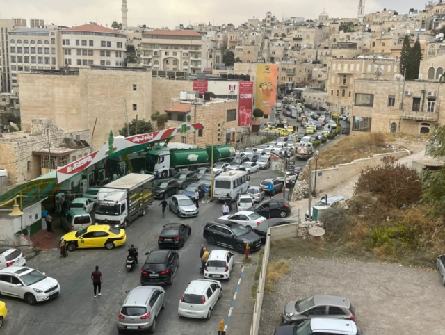 A traffic jam in Bethlehem outside the petrol station as everyone rushes to buy fuel because of the closure