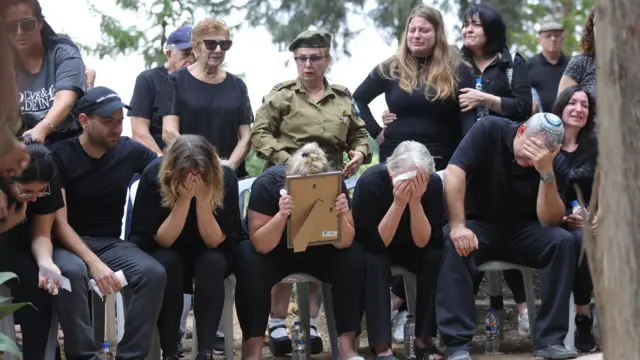 Family members mourn during the funera