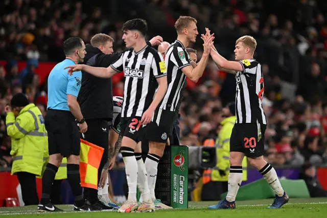 Lewis Hall of Newcastle United interacts with Dan Burn