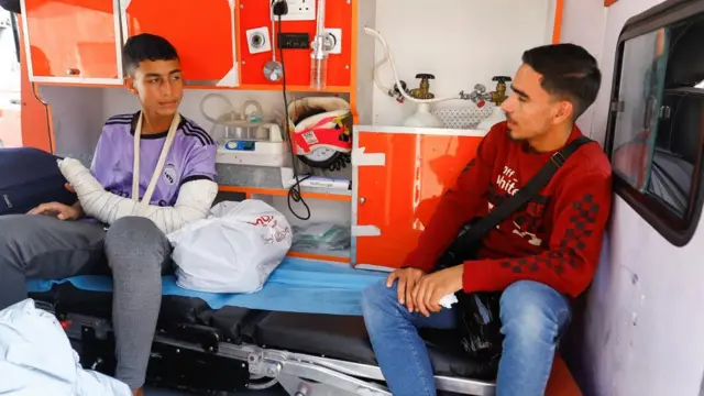 An injured Palestinian sits inside an ambulance, as medical workers wait to transport injured Palestinians to receive treatment in Egyptian hospitals, at the Rafah border crossing with Egypt, in the southern Gaza Strip, November 1, 2023.