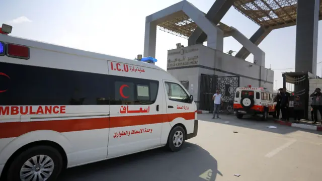 Ambulances drive through the Rafah border crossing.