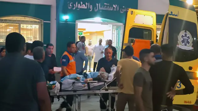 Staff take an injured person into the hospital in Egypt.