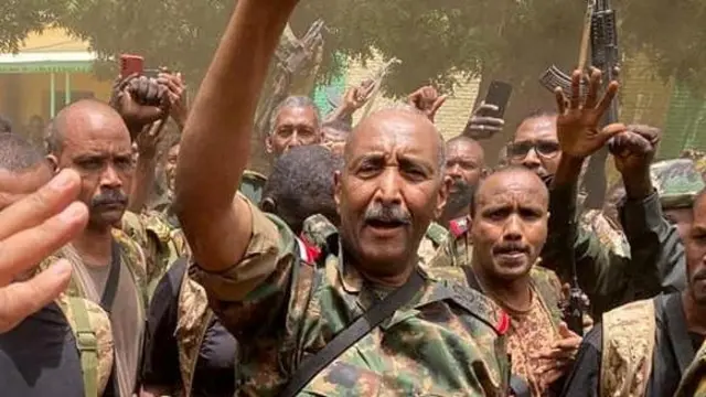 Sudan's General Abdel Fattah al-Burhan stands among troops, in an unknown location, in this picture released on May 30, 2023.