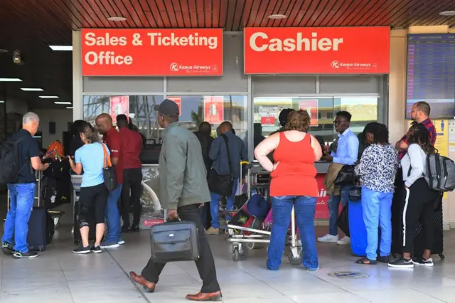 Passengers attempt to book flights at a sales and ticketing office, amid a strike by pilots organised by Kenya Airline Pilots Association (KALPA), at the Jomo Kenyatta International airport in Nairobi taken on November 5, 2022.