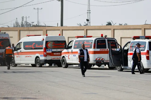 Medical workers wait to take Palestinians who will receive treatment in Egyptian hospitals, at the Rafah border crossing with Egypt, in the southern Gaza Strip, November 1, 2023.