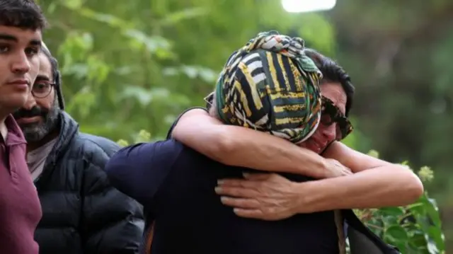 Mourners embrace as friends and family attend the funeral of staff sergeant Lavi Lipshitz, 20, who was killed in the northern Gaza Strip, amid the ongoing ground operation of the Israeli army against Palestinian Islamist group Hamas, at Mount Herzl Military Cemetery in Jerusalem, November 1, 2023.