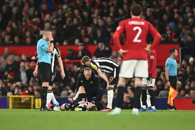 Matt Targett on the pitch with a physio