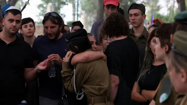 Mourners embrace as friends and family attend the funeral of staff sergeant Lavi Lipshitz, 20, who was killed in the northern Gaza Strip, amid the ongoing ground operation of the Israeli army against Palestinian Islamist group Hamas, at Mount Herzl Military Cemetery in Jerusalem, November 1, 2023.