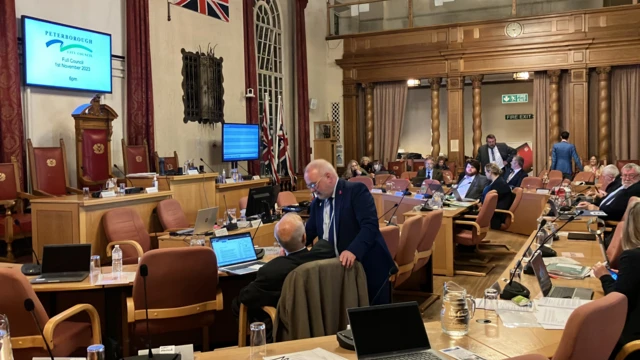 The interior of the council chamber at Peterbporough Town Hall. It shows councillors talking ahead of the meeting.