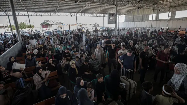 People waiting at Rafah where a few hundred people with foreign passports are being allowed to cross from Gaza into Egypt