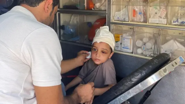 Description Palestinian boy Ameer Joma, who was injured in an Israeli strike, sits with his father in an ambulance as they wait to be transported for treatment in an Egyptian hospital, at the Rafah border crossing in the southern Gaza Strip, November 1, 2023