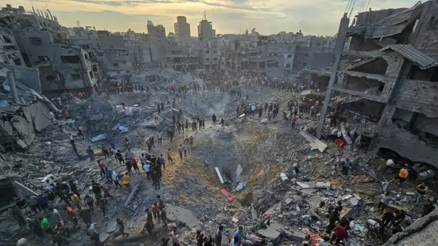 Palestinians search for casualties at the site of Israeli strike in Jabalia refugee camp