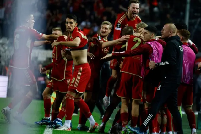 Aberdeen players celebrate a goal against PAOK Salonika