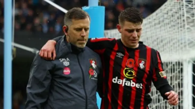 Bournemouth's Alex Scott leaves the field with an injury