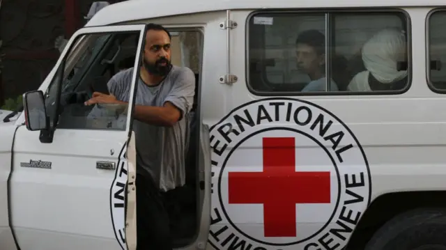 A man exits an ICRC vehicle