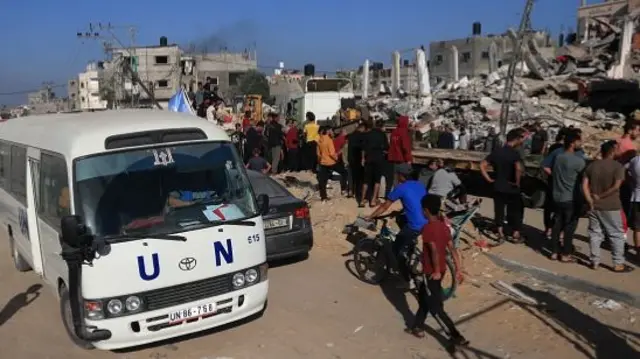 A UN bus drives past a destroyed building following the Israeli bombardment of Rafah