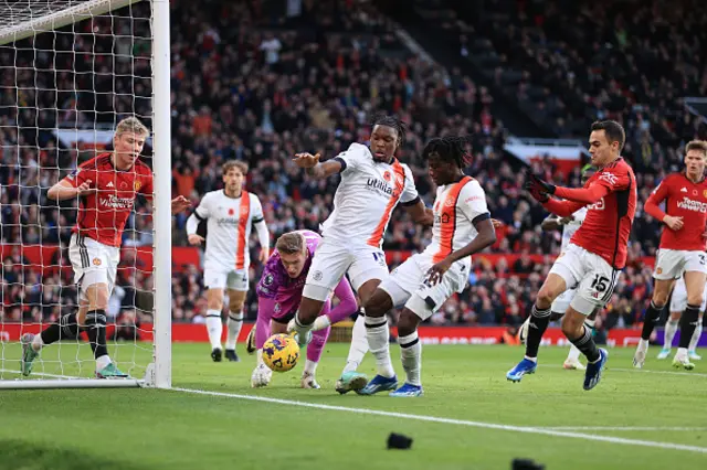 Teden Mengi of Luton Town and Issa Kabore of Luton Town combine to clear the ball