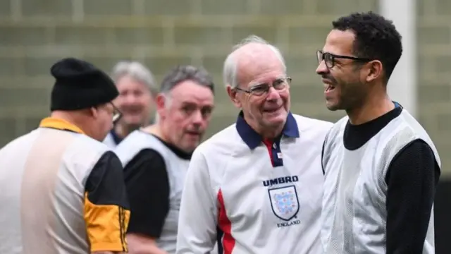 Hull City manager Liam Rosenior (right) plays in a game of walking football for over-55s, run by the Tigers Trust