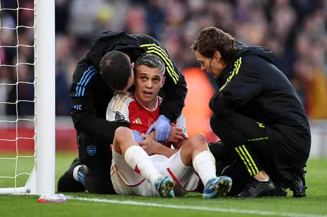 Leandro Trossard of Arsenal receives medical treatment