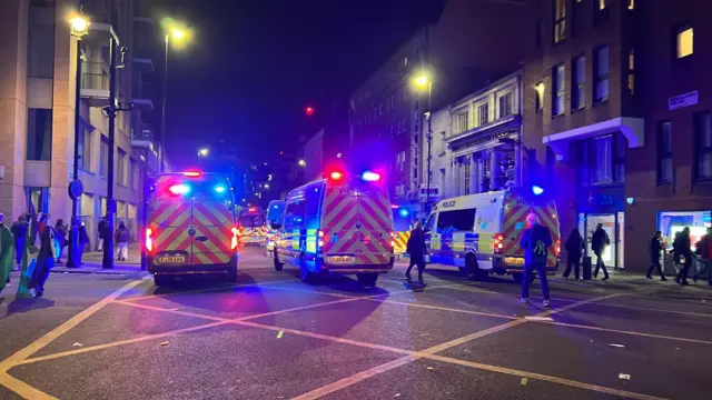Three police vans patrol the march