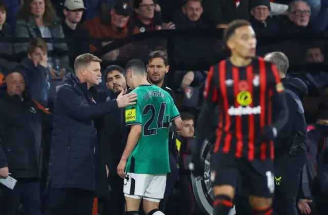 Miguel Almiron walks past Eddie Howe