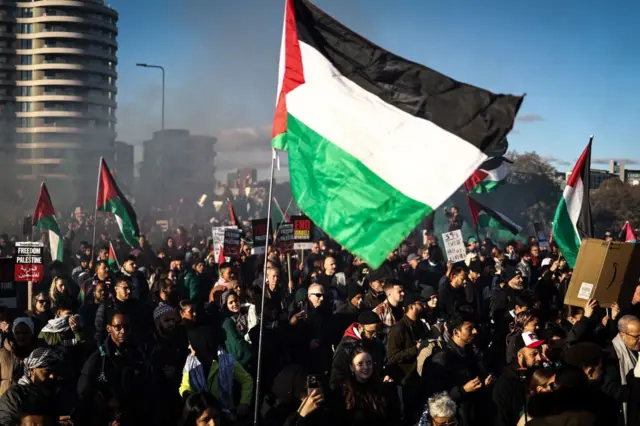 Pro-Palestinian demonstrators march through London