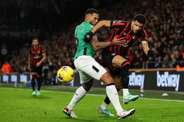 Dominic Solanke and Jamaal Lascelles battle for the ball