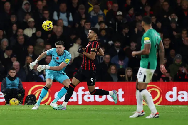 Nick Pope clears the ball unde pressure form Dominic Solanke