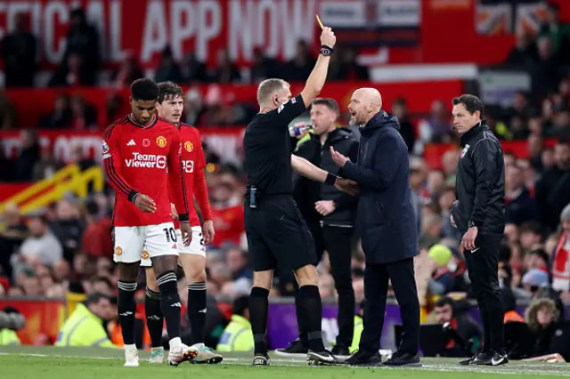 Referee Graham Scott shows a yellow card to Erik ten Hag