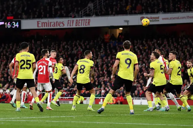 Oleksandr Zinchenko shoots as players look on