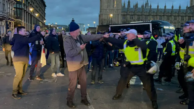 Counter-protestors and police in a fight
