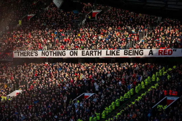 Old Trafford fans pictured seated in the stands